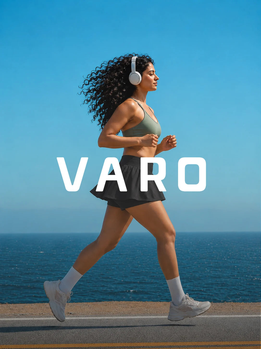 Woman running on a road with headphones, ocean in the background, featuring the brand 'VARO'.