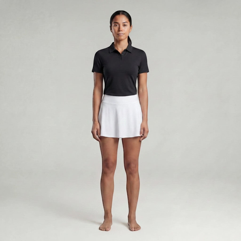 VARO Barely There black polo shirt with seamless bonded construction worn by a model with a white athletic skirt.