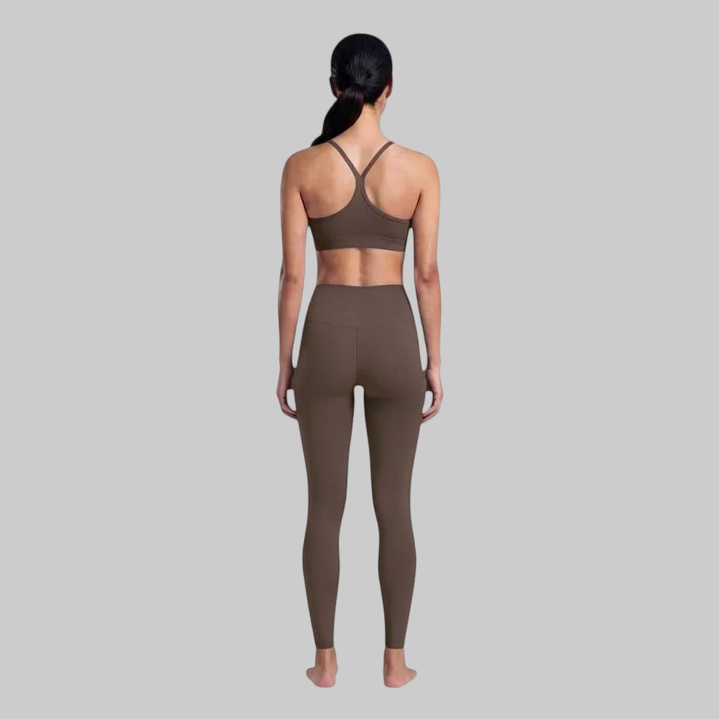 VARO On Repeat bra in brown recycled nylon with racerback design, worn by a model from the back view.