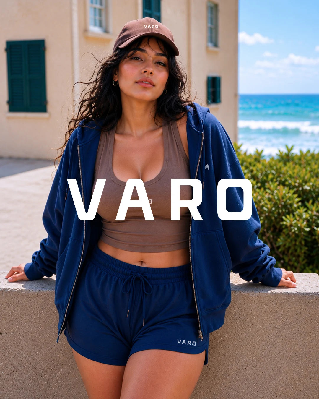 VARO Woman in athletic wear with 'VARO' branding by the ocean