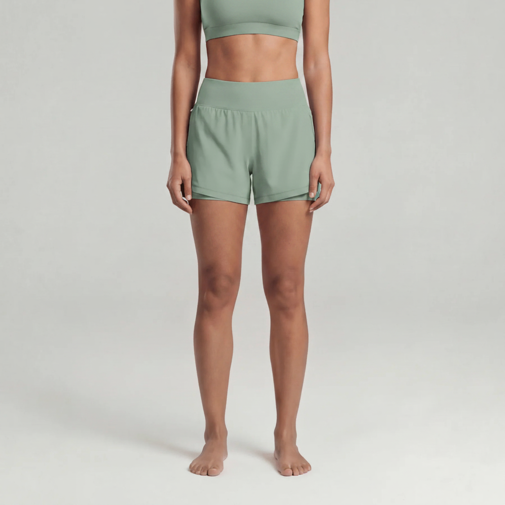 A woman wearing green athletic shorts and a green sports bra
