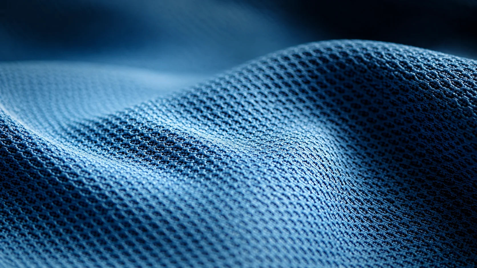 Close-up of blue textured fabric with a dark background