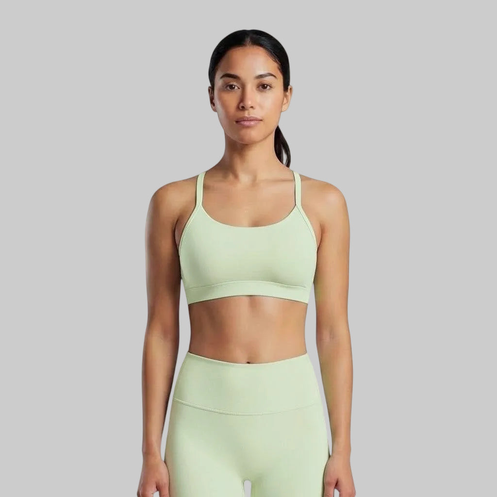VARO On Repeat light green sports bra with racerback design, made from soft recycled nylon for studio workouts.