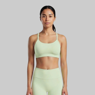 VARO On Repeat light green sports bra with racerback design, made from soft recycled nylon for studio workouts.