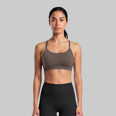 VARO On Repeat bra in taupe, a soft, low-impact recycled nylon sports bra worn by a model against a white background.